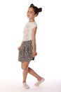 Beautiful brunette little girl 12 years old posing in a skirt with bare legs Royalty Free Stock Photo