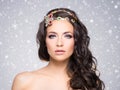 Attractive, curly brunette with flower alike golden headband wit Royalty Free Stock Photo