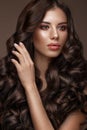 Beautiful brunette model: curls, classic makeup and full lips. The beauty face. Royalty Free Stock Photo