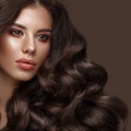 Beautiful brunette model: curls, classic makeup and full lips. The beauty face. Royalty Free Stock Photo