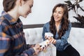 Beautiful brunette mom is choosing cosmetics with her teen smiling daughter Royalty Free Stock Photo