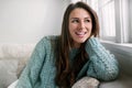 Candid lifestyle head shot of beautiful young woman smiling at home, perfect straight white teeth and cheerful expression