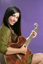 Beautiful brunette playing acoustic guitar Royalty Free Stock Photo