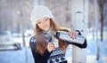 Beautiful brunette pours coffee from a thermos for a walk in winter