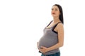 Beautiful brunette pregnant woman touching her belly and looking up isolated on white background Royalty Free Stock Photo