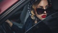 Beautiful brunette sexy spy agent killer or police woman in leather jacket and jeans with a gun in her hand driving a car after Royalty Free Stock Photo