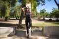 beautiful, brunette Spanish woman with black sunglasses. The woman is in the park lying on a park hill. The woman is smiling Royalty Free Stock Photo