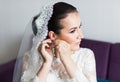 Beautiful brunette stylish bride getting ready in the morning