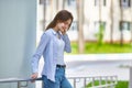 Beautiful brunette teen girl with braces on her teeth. Smiling walking on the street on a sunny summer day in the city. Royalty Free Stock Photo