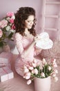 Beautiful brunette teen girl portrait open present, romantic surprise. pretty woman in pink dress over bouquet of flowers and gif Royalty Free Stock Photo