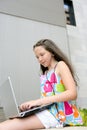 Beautiful brunette teen little girl laptop city Royalty Free Stock Photo