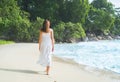 Beautiful brunette walking among the seacoast Royalty Free Stock Photo