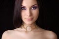 Beautiful brunette wearing golden necklace Royalty Free Stock Photo
