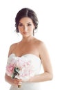 Beautiful brunette woman as bride with pink wedding bouquet on white Royalty Free Stock Photo