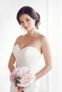 Beautiful brunette woman as bride with pink wedding bouquet on white Royalty Free Stock Photo