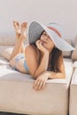 Beautiful brunette woman on the beach alone relaxing in a hat. Summer. Outdoors. Copy space Royalty Free Stock Photo