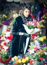 Beautiful brunette woman in black at florist shop Royalty Free Stock Photo