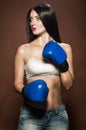 Beautiful brunette woman with blue boxing gloves Royalty Free Stock Photo