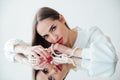 portrait of a beautiful brunette woman at the mirror with pearl beads Royalty Free Stock Photo