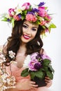 Beautiful brunette woman with a bunch of spring flowers, makeup Royalty Free Stock Photo