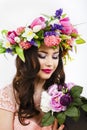 Beautiful brunette woman with a bunch of spring flowers, makeup Royalty Free Stock Photo