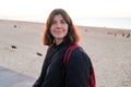 Beautiful brunette woman in casual winter jacket walking weekend on beach autumn coast Royalty Free Stock Photo