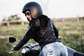 Beautiful brunette woman with a classic motorcycle c