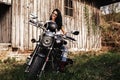 Beautiful brunette woman with a classic motorcycle c