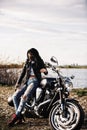 Beautiful brunette woman with a classic motorcycle c