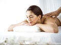 Beautiful brunette woman enjoying back massage comfortable and blissful. Spa and medicine concept Royalty Free Stock Photo