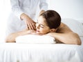 Beautiful brunette woman enjoying back massage comfortable and blissful. Spa and medicine concept Royalty Free Stock Photo