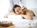 Beautiful brunette woman enjoying back massage comfortable and blissful. Spa and medicine concept Royalty Free Stock Photo