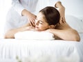 Beautiful brunette woman enjoying back massage comfortable and blissful. Spa and medicine concept Royalty Free Stock Photo