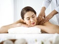 Beautiful brunette woman enjoying back massage comfortable and blissful. Spa and medicine concept Royalty Free Stock Photo