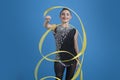 Beautiful brunette woman gymnast training calilisthenics exercise with ribbon on studio background. Art gymnastics Royalty Free Stock Photo