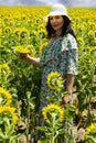 Beautiful brunette woman in sunflowers field Royalty Free Stock Photo