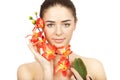 Beautiful brunette woman holding branch of orchid