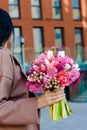 Beautiful brunette woman holding bridal bouquet in pink lilac tones made of hyacinth, tulips and gypsophila Royalty Free Stock Photo