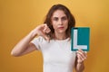 Beautiful brunette woman holding l sign for new driver with angry face, negative sign showing dislike with thumbs down, rejection Royalty Free Stock Photo