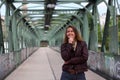 Beautiful brunette woman with leather jacket on an iron bridge Royalty Free Stock Photo