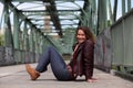 Beautiful brunette woman with leather jacket on an iron bridge Royalty Free Stock Photo