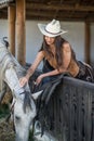 Portrait of a girl with cowboy hat and her horse. Royalty Free Stock Photo