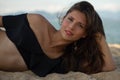 Beautiful brunette woman lying and relaxing on the beach Royalty Free Stock Photo