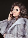 Beautiful brunette woman in mink fur coat isolated on black back Royalty Free Stock Photo