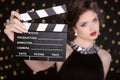 Beautiful brunette woman model holding film clap board cinema Royalty Free Stock Photo