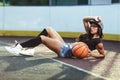 Beautiful brunette woman playing basketball on court outdoor Royalty Free Stock Photo