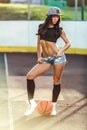 Beautiful brunette woman playing basketball on court outdoor Royalty Free Stock Photo