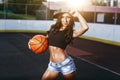 Beautiful brunette woman playing basketball on court outdoor Royalty Free Stock Photo