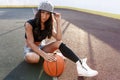 Beautiful brunette woman playing basketball on court outdoor Royalty Free Stock Photo