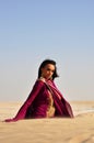 Beautiful brunette woman posing in arabic desert Royalty Free Stock Photo